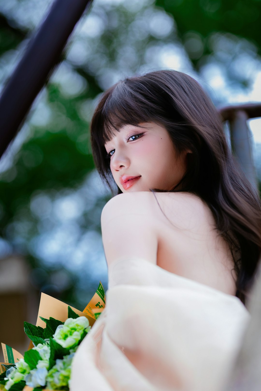 Young woman with dark hair holding flowers